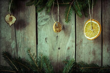 Spruce branches with ornaments on an old wooden board.の写真素材