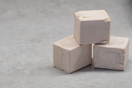 Yeast cubes on an old stone slab.