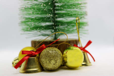 Handmade Christmas tree with Gold-colored bells and balls,  Green Christmas tree ,Bells with red bows, Christmas decoration on white background, New Year's decoration, Holidays greeting card,の写真素材