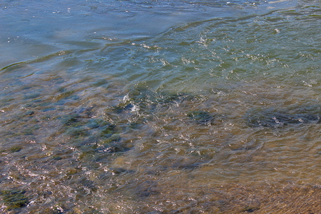 background texture of small waves of clean waterの写真素材