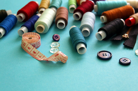 a lot of spoils of threads scattered on the table