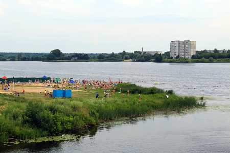 people rest on the beach on the river bankの写真素材