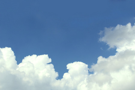 Blue sky with white fluffy big cloudsの写真素材