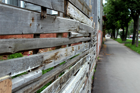 a wooden fence is standing in the streetの写真素材