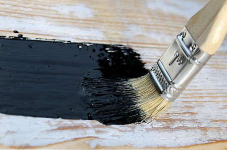 black paint with a brush for the painting surfacesの写真素材