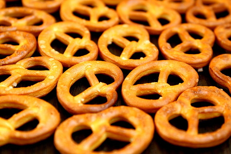 salted crispy fresh pretzels lie on the tableの写真素材