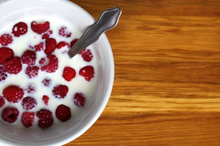 Raspberry ripe juicy floats in a bottle with a spoonの写真素材