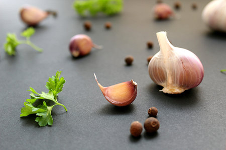 still life of garlic cloves parsley and bell pepper