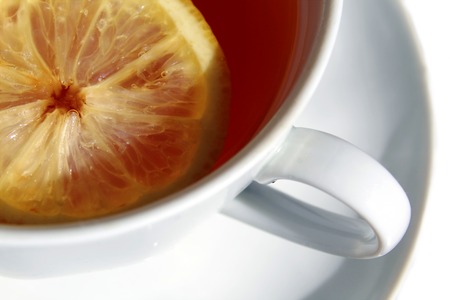 a cup of tea with a slice of lemonの写真素材