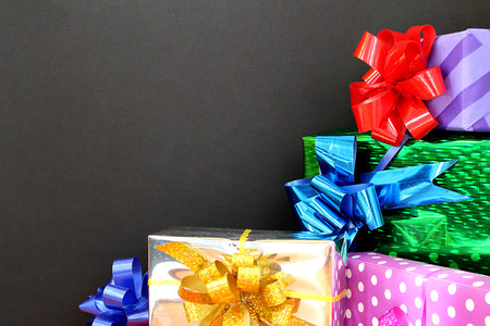 bright boxes a lot of gift for a holiday on a black backgroundの写真素材