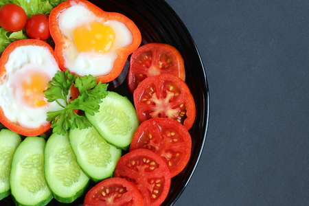 easy breakfast fried egg and fresh vegetablesの写真素材