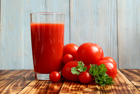 a glass of tomato juice with tomatoesの写真素材