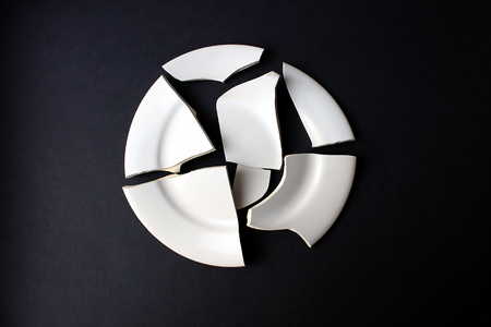 A broken white porcelain dish that does not stick togetherの写真素材