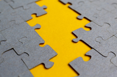 Texture puzzles gray on a yellow backgroundの写真素材