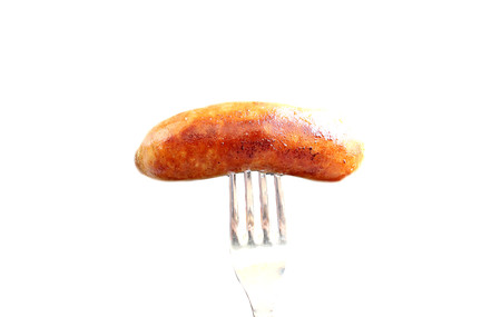 fried sausage roasted on a forkの写真素材
