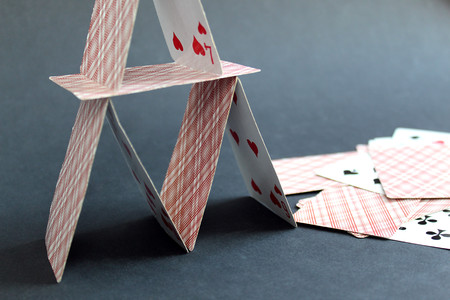 House built from playing cards on a black backgroundの写真素材