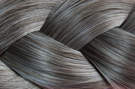 Texture close-up of braided hair gray color backgroundの写真素材