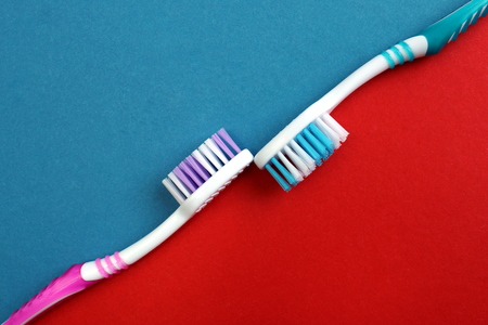 Two toothpastes on a red and blue backgroundの写真素材
