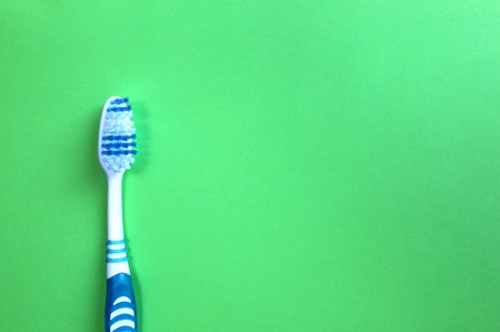 One toothbrush lies on a green backgroundの写真素材