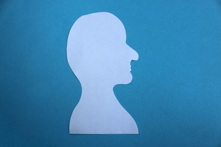 Man silhouette cut out of white paperの写真素材