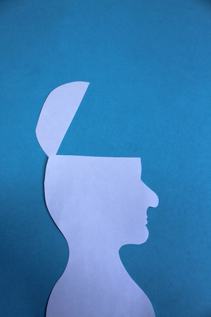 Silhouette of a man of white paper with half the head cut offの写真素材
