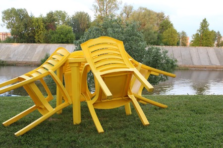 There is a table with sloping chairs after the rainの写真素材