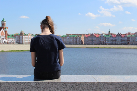 Sad girl looks backの写真素材