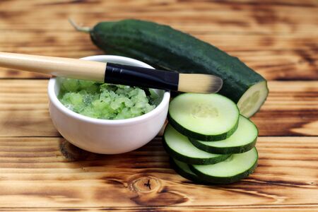 Bowl with cucumber and brushの写真素材