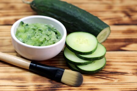 Bowl with cucumber and brushの写真素材