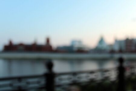 Blurred background. Evening city embankment riverbank.の写真素材