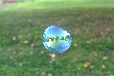 a large soap bubble in which nature is reflectedの写真素材