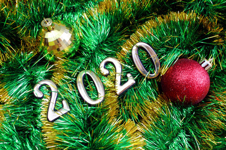 texture shiny christmas green tinsel with christmas toys and numbers 2020