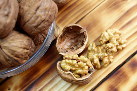 chopped walnuts lie on a wooden table