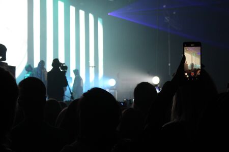 blurry photo from a concert where people relaxの写真素材