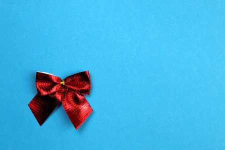 one red bow on a blue background