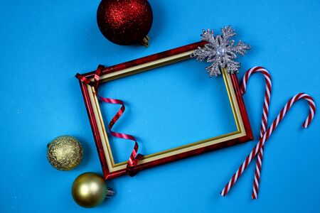 Photo frame with Christmas decorations on a blue backgroundの写真素材