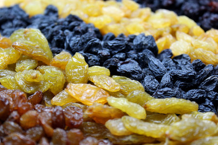 Texture of assorted raisins lined with stripes, top view