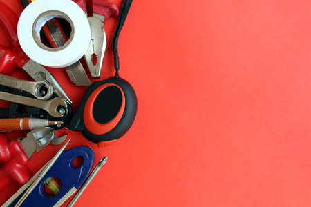 Small repair tools on a red background