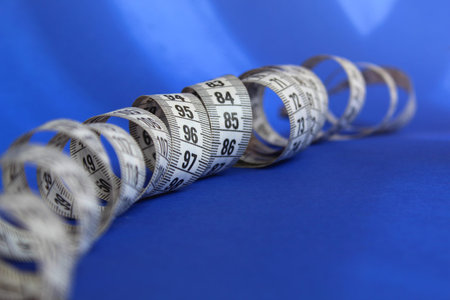 Centimeter white tape for measuring wriggle on a blue background