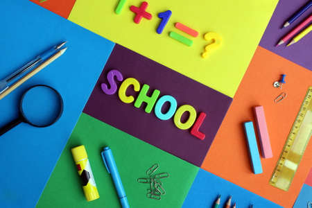 Inscription on a multi-colored surface with stationery `school`の写真素材