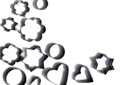 A lot of metal molds for baking cookies on a white backgroundの写真素材