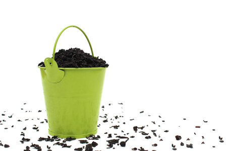 Decorative bucket with dry leaves of black loose tea