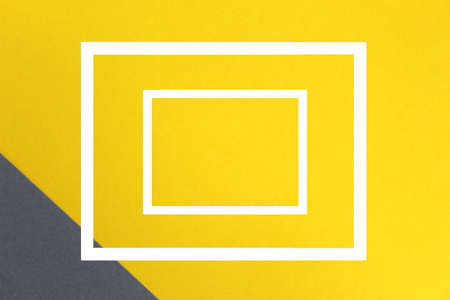 Two white frames are on yellow and grayの写真素材