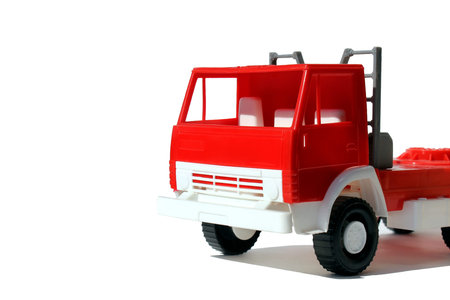 Red large cargo toy car stands on a white backgroundの写真素材
