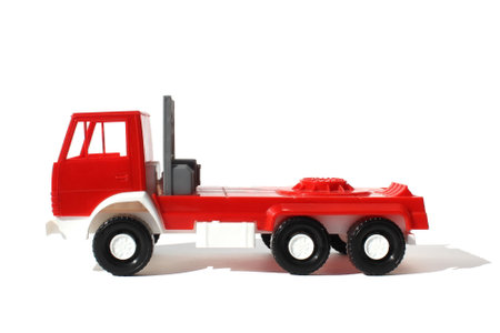 Red large cargo toy car stands on a white backgroundの写真素材