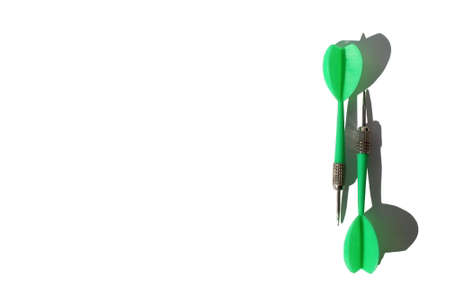 Green dart darts lie on white background with place for textの写真素材