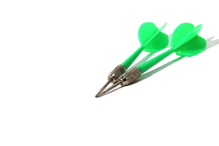 Green dart darts lie on white background with place for textの写真素材