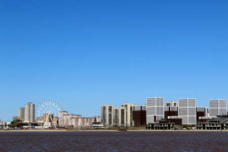 view of the city from the side of the river in early spring on a warm sunny dayの写真素材