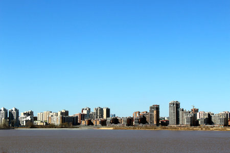 View of the city from the side of the river in early spring on a warm sunny day