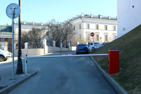 Closed barrier in a paid parking lot, warm sunny day